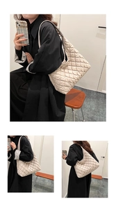 Detail view of the quilted diamond pattern and large capacity tote bag in off-white finish