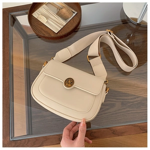 Detail of off-white retro square crossbody bag with vintage portrait buckle and wide strap
