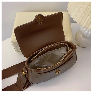 Detail view of the deep brown vintage saddle bag interior with zipper and pockets