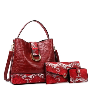 Three-piece red faux crocodile and snakeskin tote bag set with matching wallets