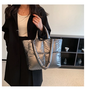 Detail of silver quilted tote bag with metallic texture and large capacity design