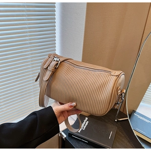Close-up of pleated cylinder shoulder bag in khaki PU leather with silver metal hardware