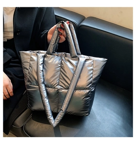Close-up of silver quilted tote bag with metallic finish and spacious padded design
