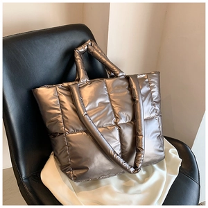 Close-up of metallic bronze quilted down tote bag with large capacity and soft texture