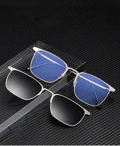 Detail of square metal magnetic clip-on sunglasses with carbon fiber texture background