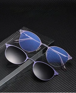 Detail of purple metal optical frame with magnetic clip-on sunglasses and star patterns