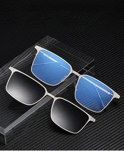 Detail view of magnetic snap-on sunglasses clip attached to a gray metallic square frame