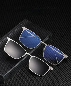 Macro view of magnetic clip-on sunglasses and silver metal half-frame optical glasses