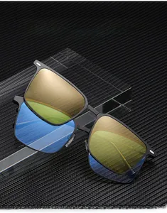 Detail of metal square frame glasses with yellow lenses on carbon fiber texture