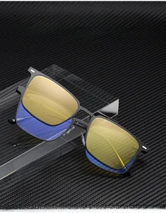 Detail of square matte black metal frame sunglasses with dual-layer lens and silver accents