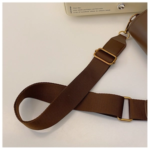 Detail of adjustable brown woven shoulder strap with vintage golden metal hardware