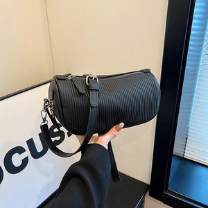 Minimalist black textured Boston bag with silver zipper and adjustable crossbody strap