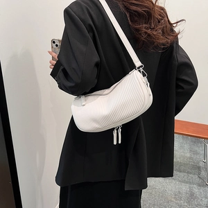 Chic white pleated cylinder shoulder bag with modern vertical ruffles and metallic zippers