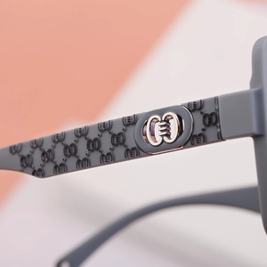 Macro shot of high-end nylon sunglasses arm with embossed texture and metal ring detail