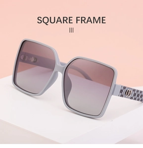 Detail of square frame sunglasses showing embossed logo texture and gradient lenses