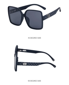 Detail of oversized square sunglasses featuring nylon frame and metal temple accents