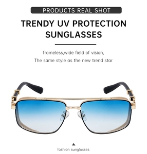 Detail of gold metal frame sunglasses with blue gradient lenses and vintage carving