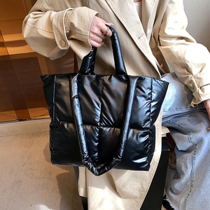 Quilted black puffer tote bag with large capacity for women shown in a lifestyle setting