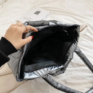 Metallic grey quilted down tote bag with spacious interior and zipper closure