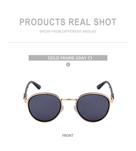 Front view of round gold frame punk sunglasses with gray lenses and black temples