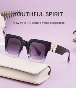 Detail of square sunglasses with purple gradient lenses and gold metal W hinge accents