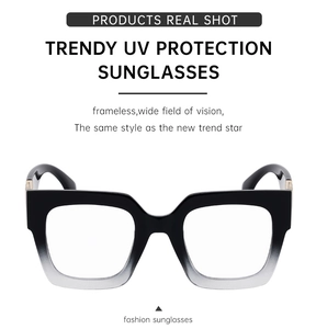 Detail view of square sunglasses featuring gradient frames and metallic logo decoration