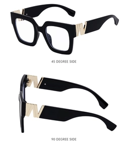 Detail view of square black sunglasses with golden side decorative metal accents