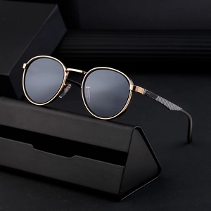 Retro punk round frame sunglasses with gold metal frame and black lenses in a sleek case