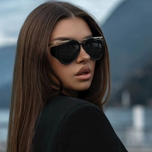 Detail of fashion cat eye sunglasses with golden metal hollow design on the temple