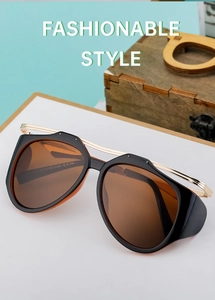 Detail of trendy sunglasses featuring gold bridge and size marking 54 18-145 on temple