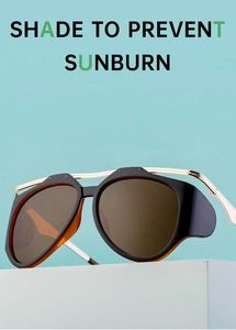 Close-up of retro black cat-eye sunglasses with side shields and gold metal temples