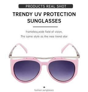 Detail of pink cat-eye sunglasses featuring UV protection lenses and silver metal bridge