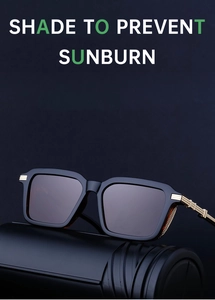 Detail view of square black sunglasses with gold metal hinges and sun protection lenses