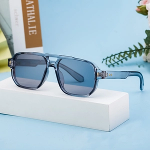 Blue transparent square pilot sunglasses with gray-blue lenses on a modern background