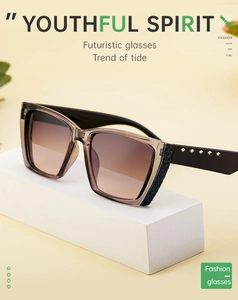 Detail of square oversized sunglasses featuring gold rivets and textured temples