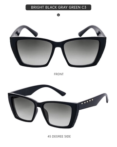 Macro view of bright black square sunglasses with gray green lenses and golden rivets