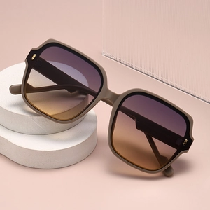 Fashion square polarized sunglasses with matte khaki frames and gradient lenses on a stone base