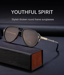 Detail of vintage aviator sunglasses on a textured leather case with metal accents