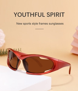 Close-up of red sporty wraparound Y2K sunglasses with dark lenses on a geometric stand