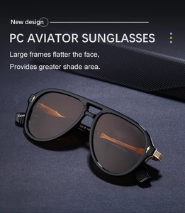 Detail view of black aviator sunglasses with gold diamond-shaped metal accents