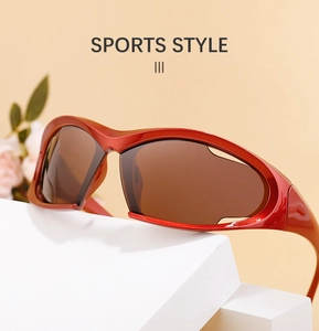 Detail view of red sporty cycling sunglasses on white geometric pedestals