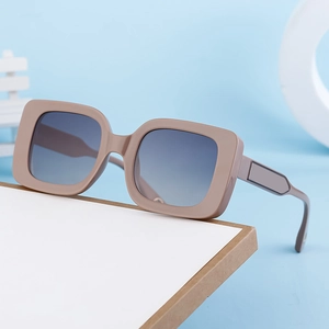 Women's chic square mocha brown sunglasses with gradient lenses on a display stand