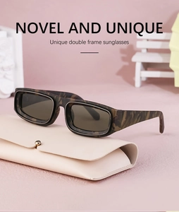 Detail of unique double-framed camouflage sunglasses with a beige leather storage case