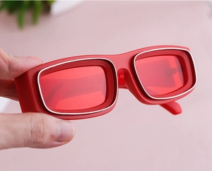 Detail of red rectangle sunglasses with double silver frame and bold Y2K style