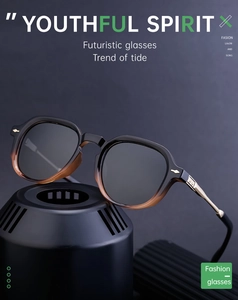 Detail of polarized sunglasses featuring gradient black amber frame and gold metal temples
