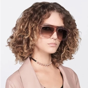 Close-up of retro square sunglasses featuring gradient lenses and transparent brown frames