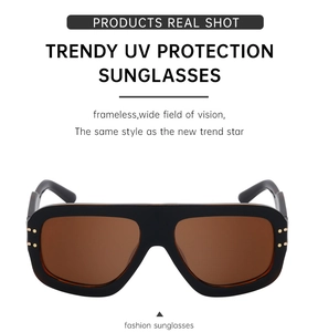 Detail of square oversized sunglasses with gold rivets and UV protection lenses