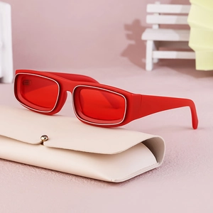 Retro red rectangular sunglasses with silver trim on a beige leather pouch