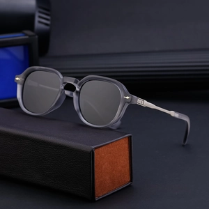 Polarized sunglasses with gray matte frame and silver metal temples on a luxury gift box
