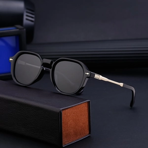 Men's polarized sunglasses with black frames and gold temples on leather box